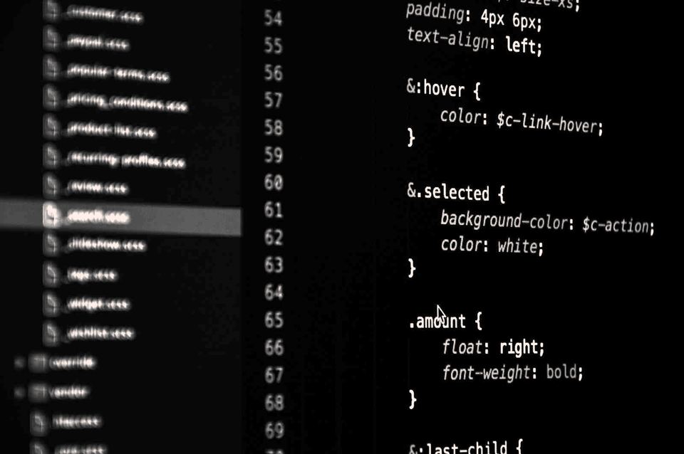 Source code on a developer's screen, in black and white
